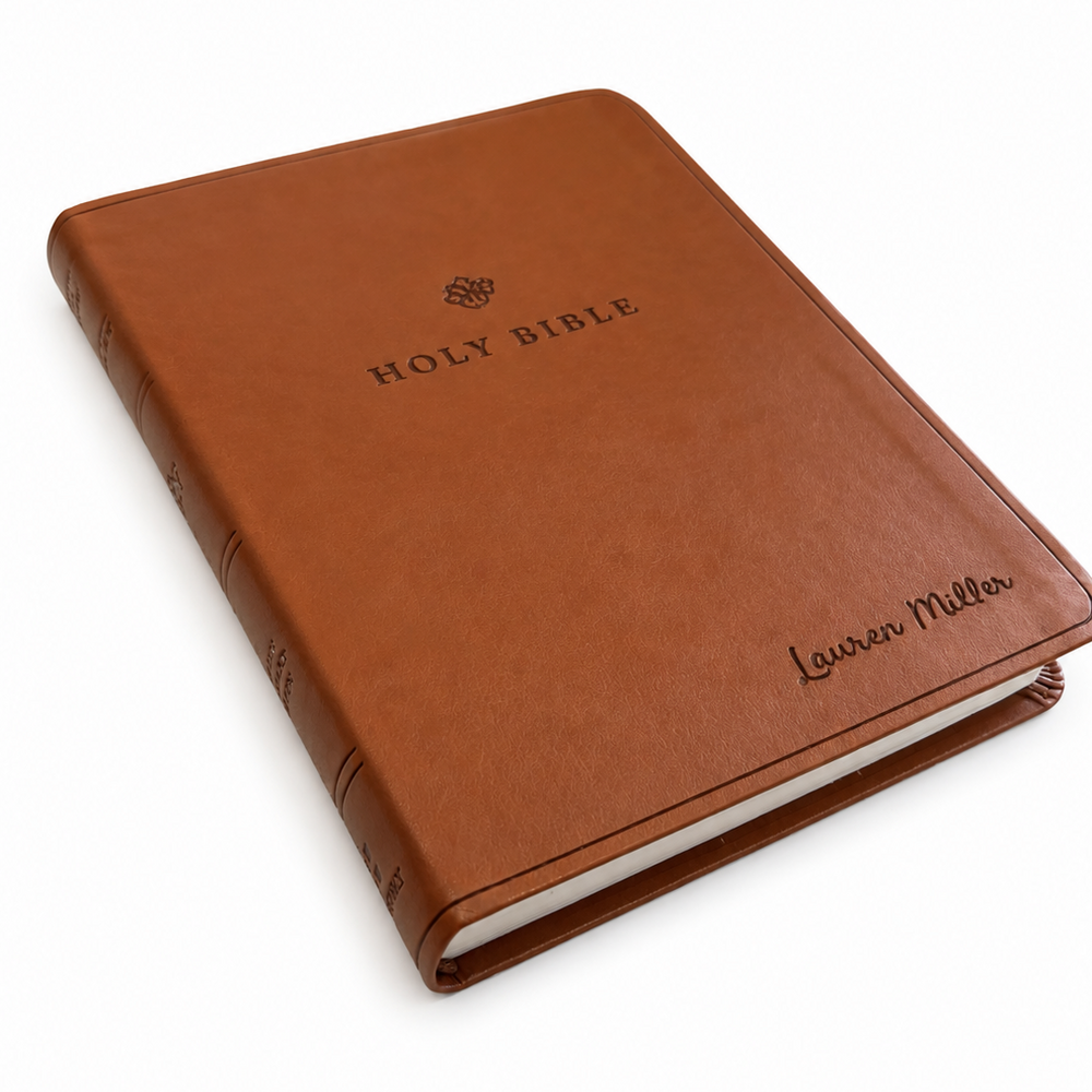 Brown leather-bound Bible with 'HOLY BIBLE' and 'Lauren Miller' branding on a white background