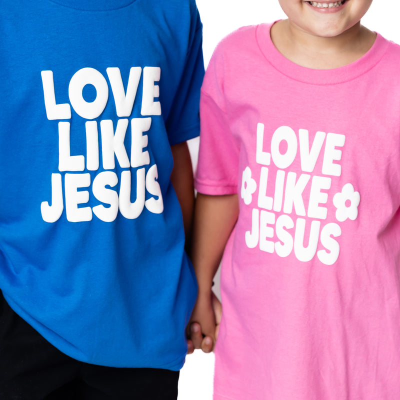 Two children wearing t-shirts with 'Love Like Jesus' text, one blue and one pink.