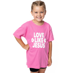 Young girl wearing a pink t-shirt with 'Love Like Jesus' text on a white background